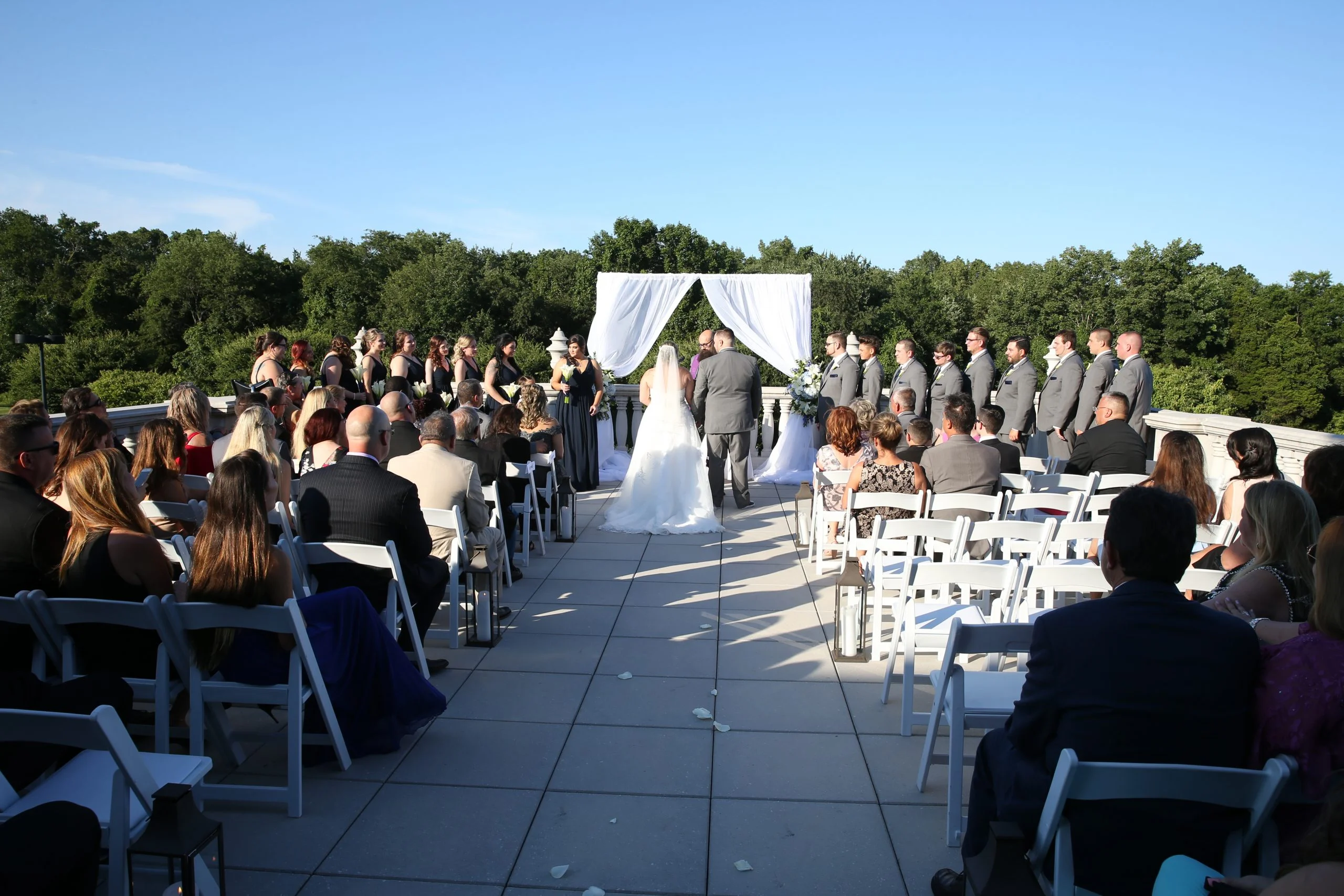 A wedding ceremony on the roof of a building.