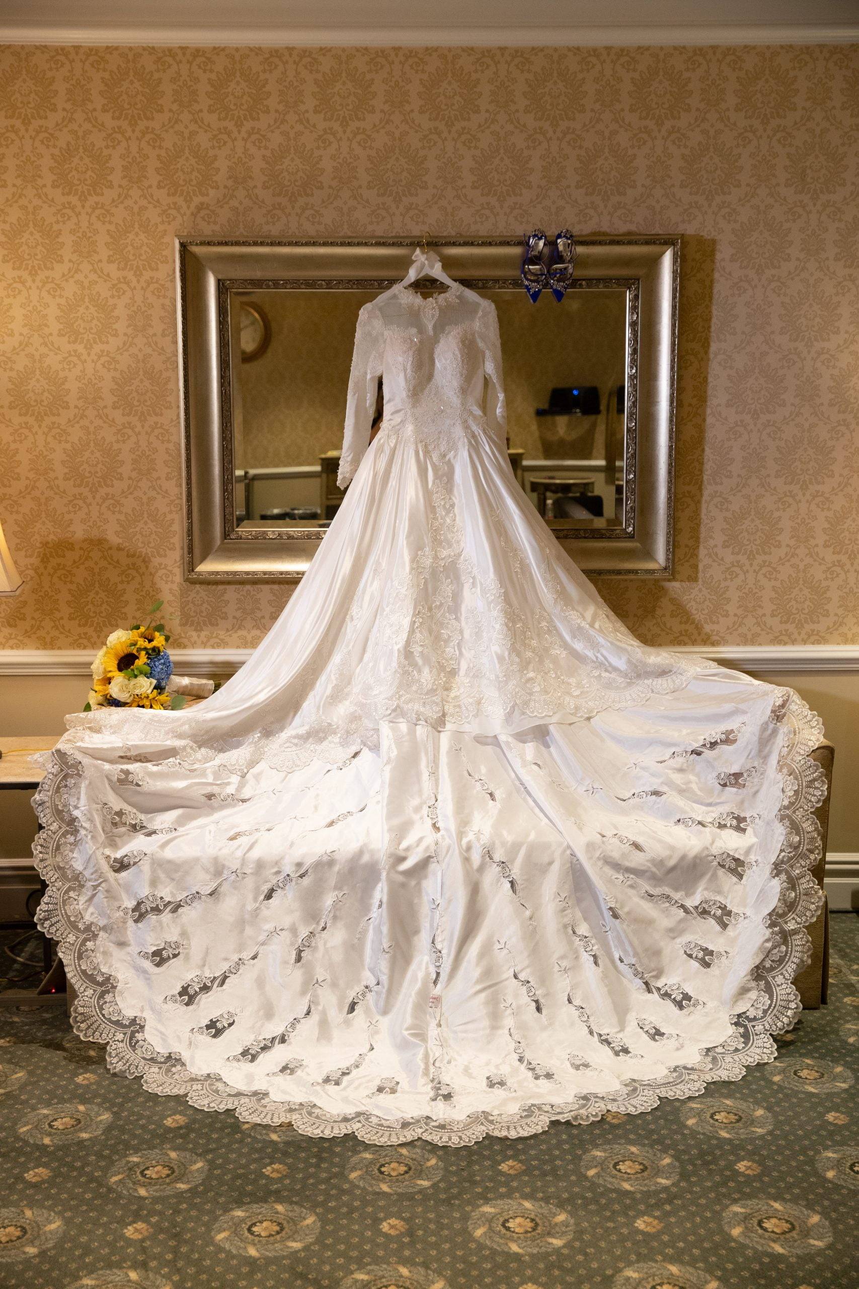 A wedding dress is on display in a hotel room.
