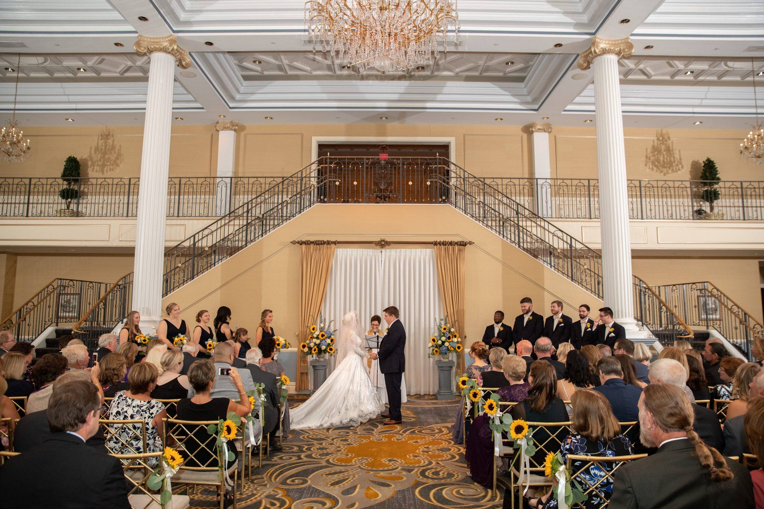 A wedding ceremony in the ballroom of a hotel.