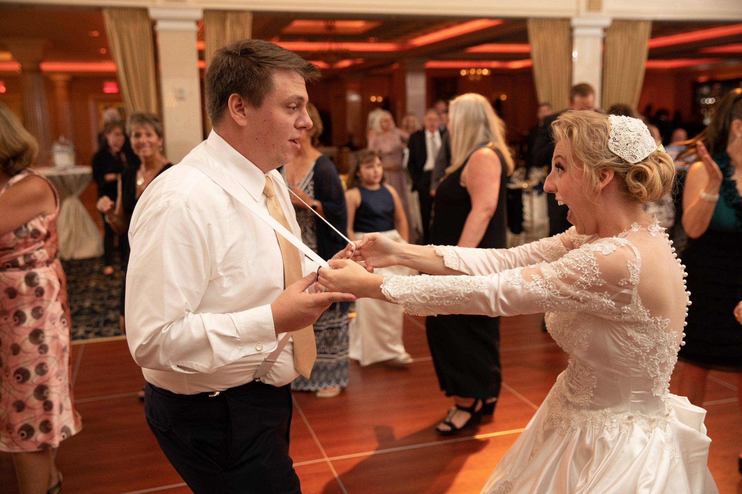 A bride and groom dancing at a wedding reception.