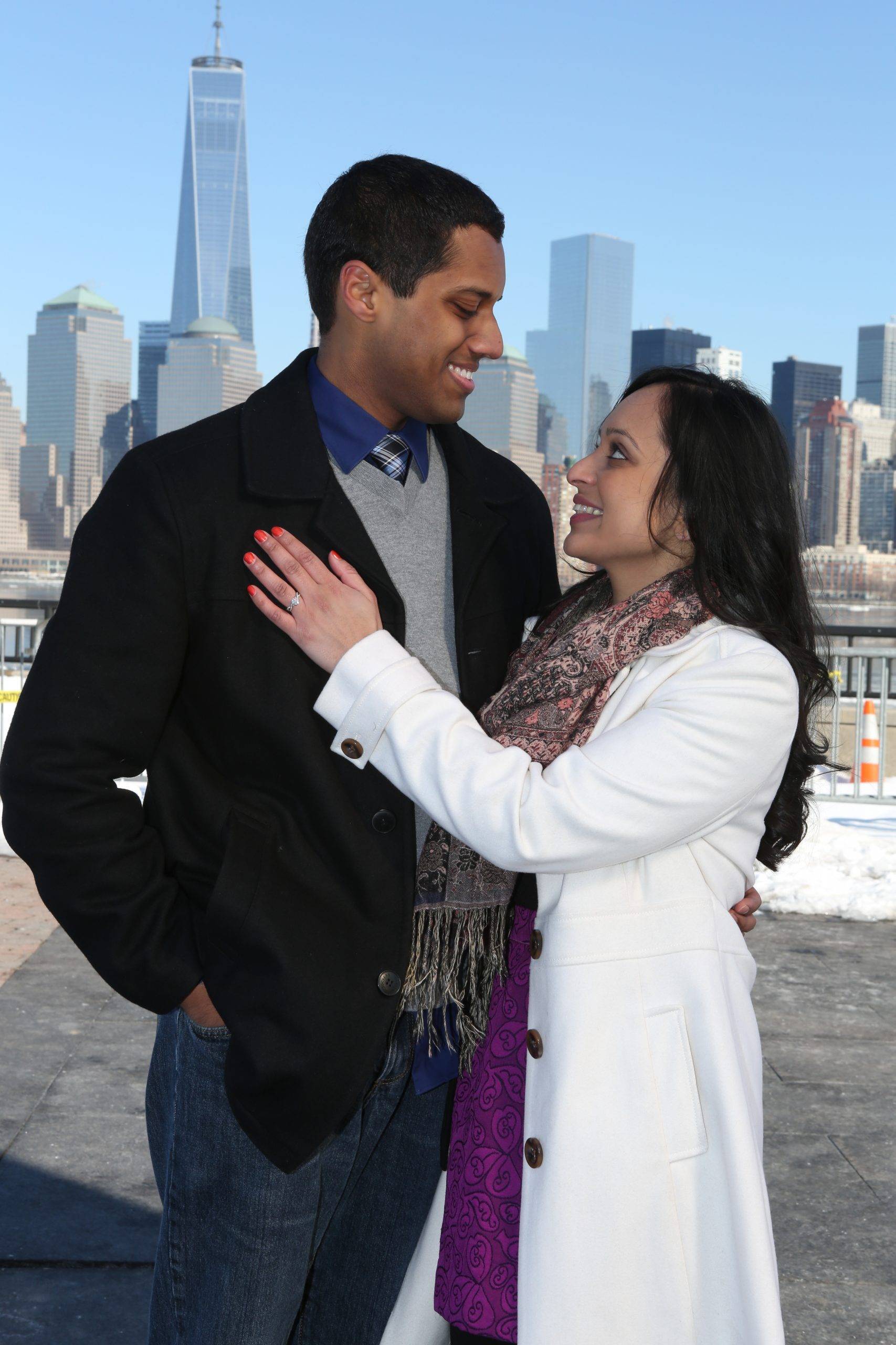A man and woman standing in front of a city skyline.