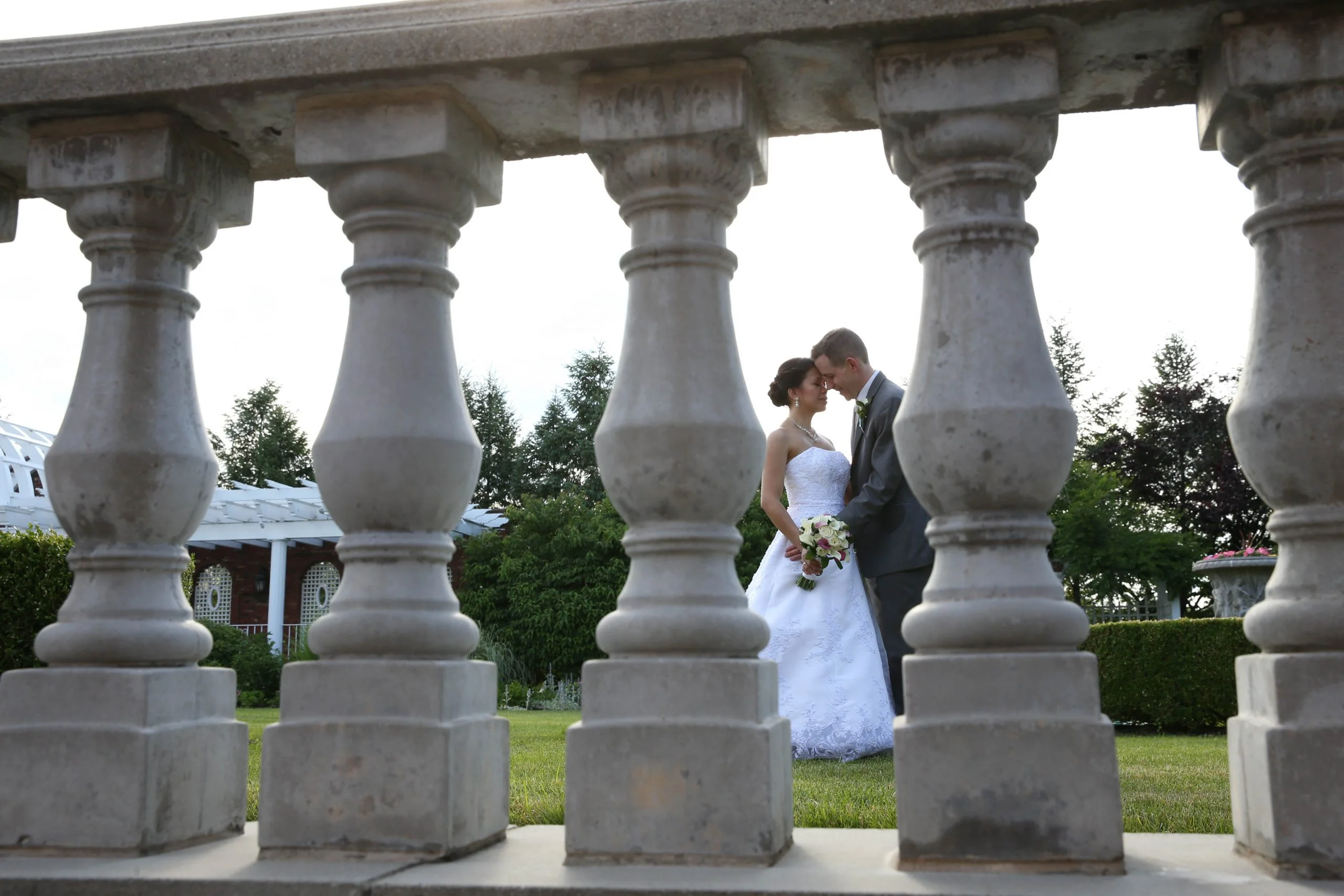 Birchwood Manor bride and groom through railing